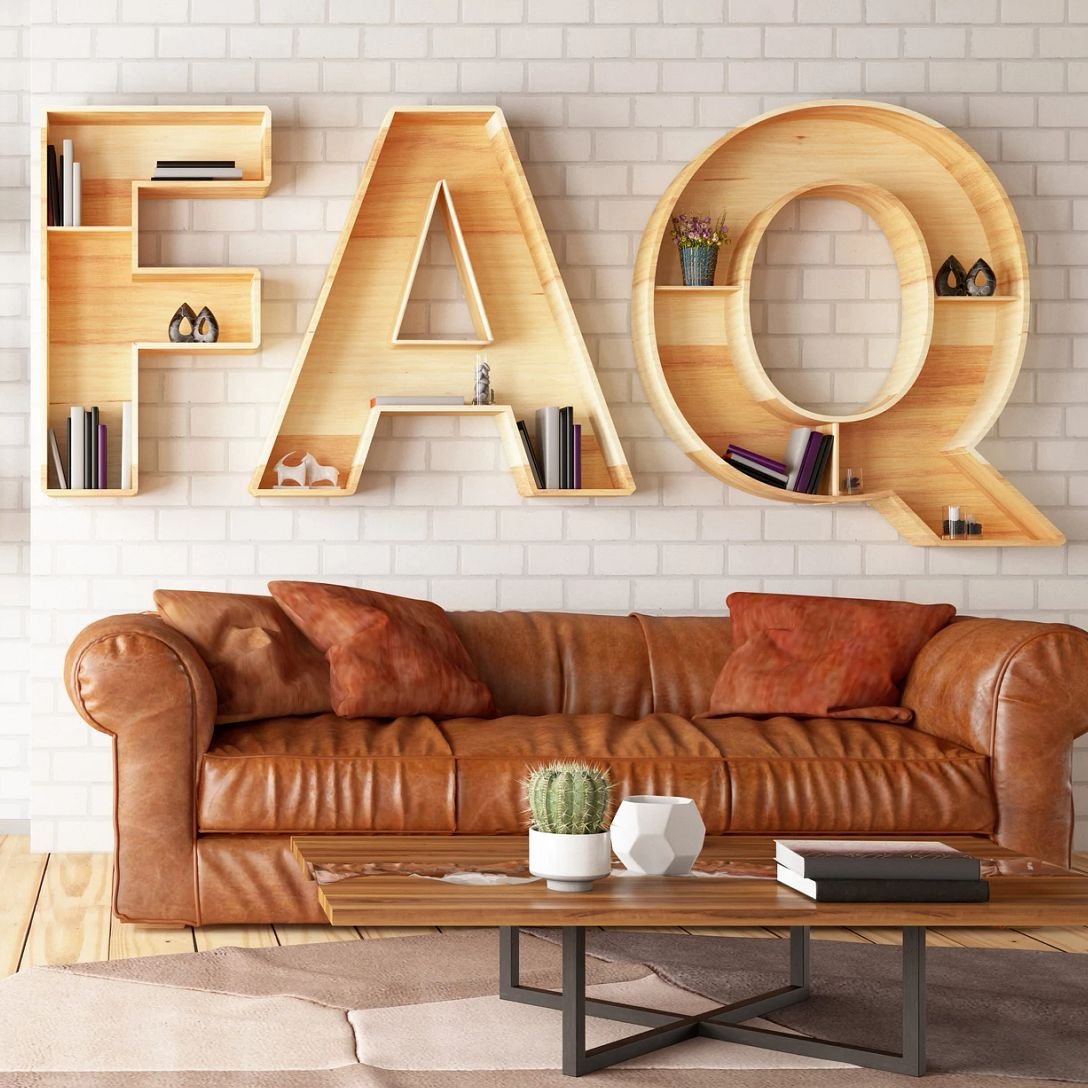 large wood letters spelling FAQ above a leather sofa